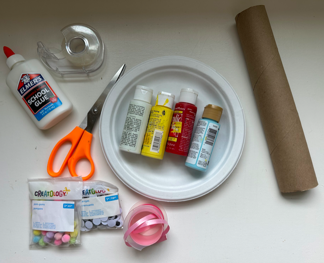Top shot of art supplies like scissors, paint, and glue.