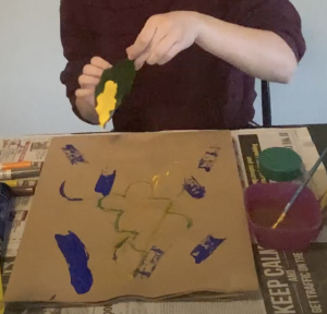 working on craft paint over a bag.