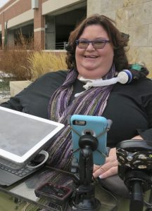 Woman in a wheelchair smiling.