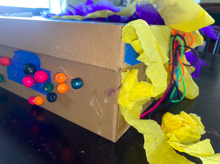beads and yellow streamers on side of box.